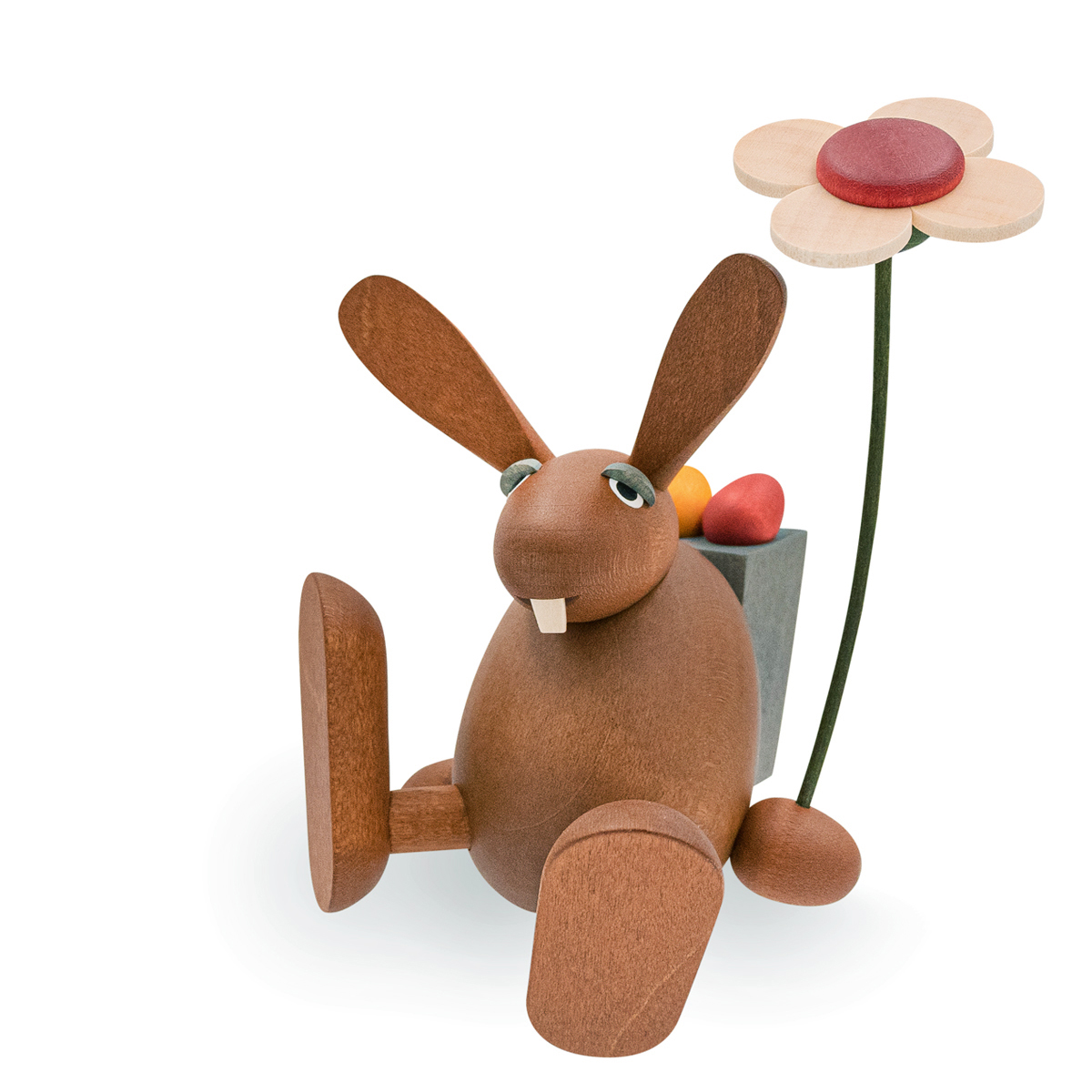 Osterhase mit Blume auf Kante sitzend / tanzend