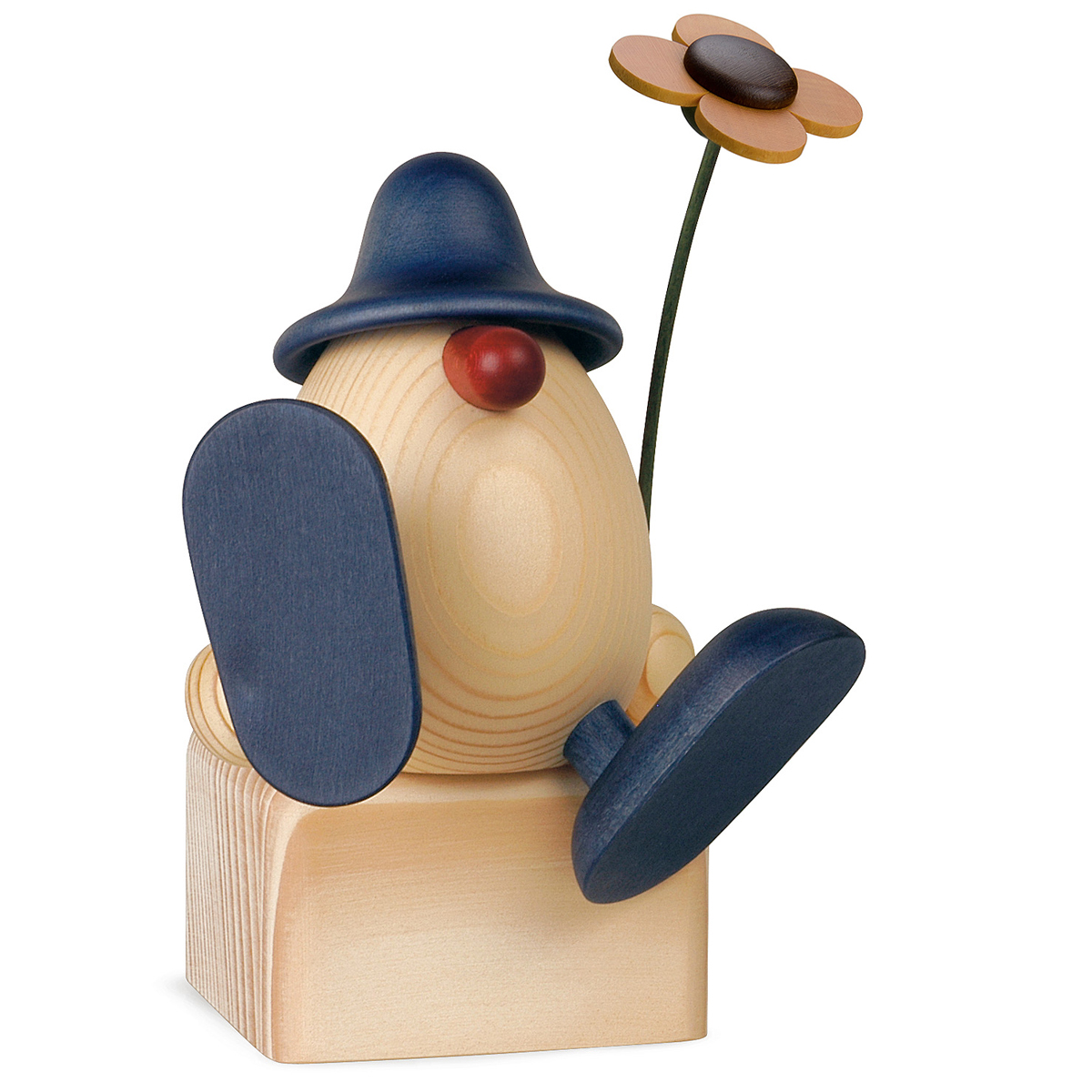 Eierkopf Alfons mit Blume auf Kante sitzend/tanzend, blau (ohne Klotz)