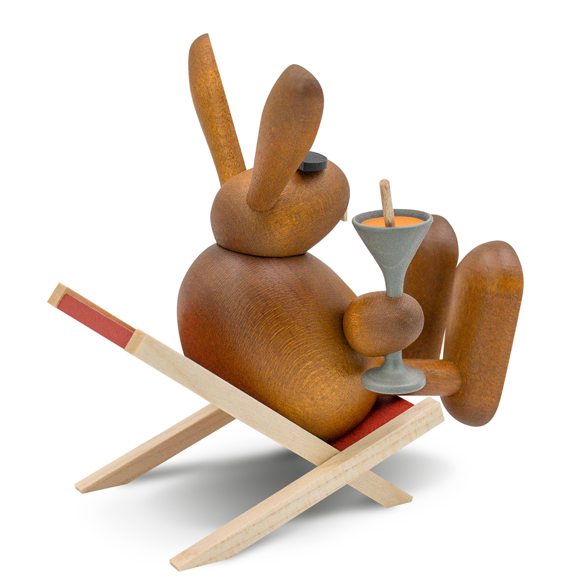Easter bunny with carrot juice on the sun lounger