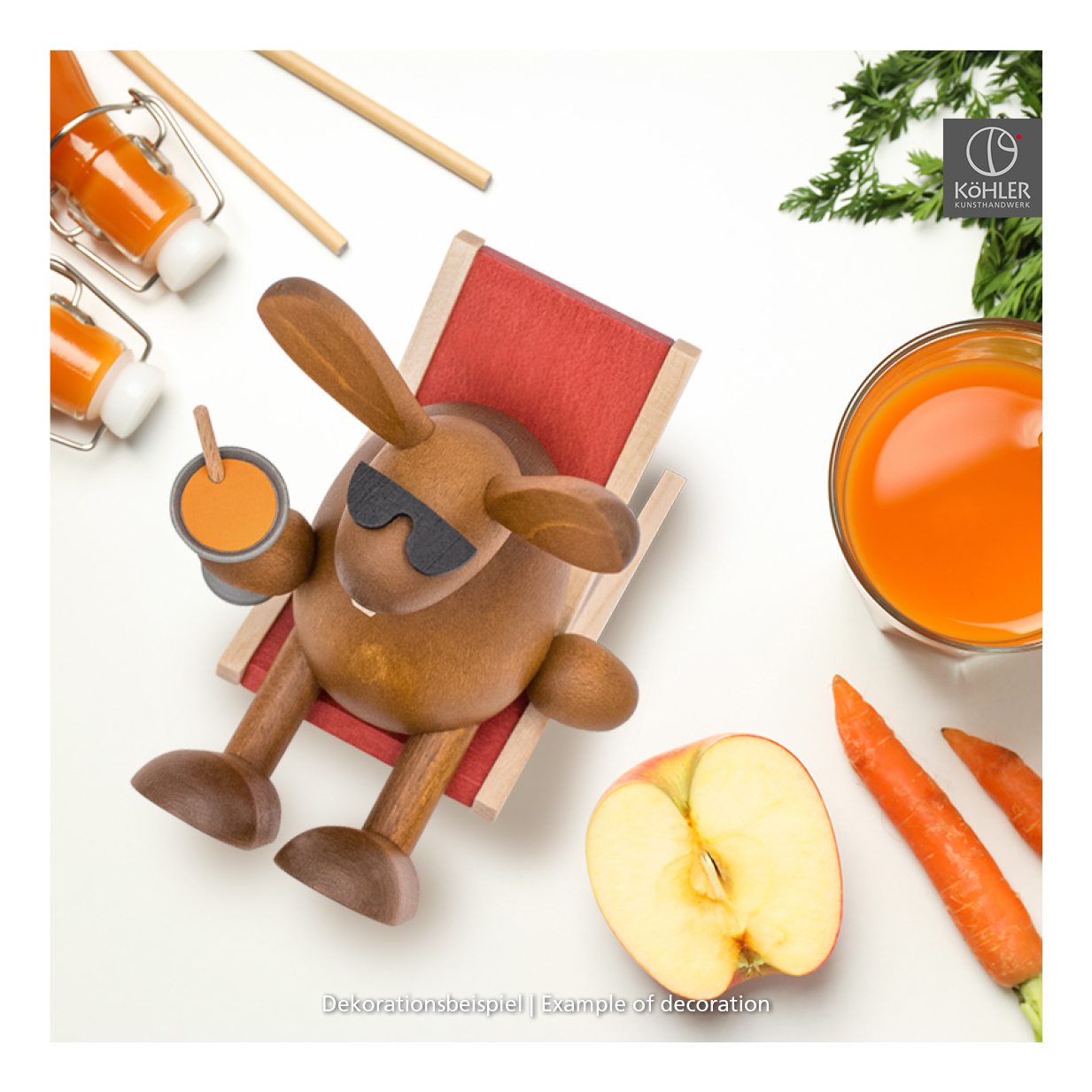 Easter bunny with carrot juice on the sun lounger